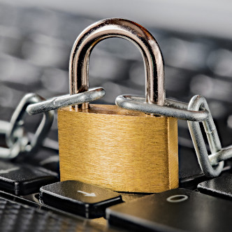 A padlocked chain on a keyboard, representing secure file transfer.