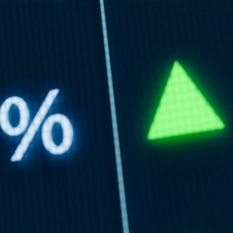 A stock ticker with a percentage sign and green arrow.